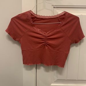 Pink blouse with lace collar